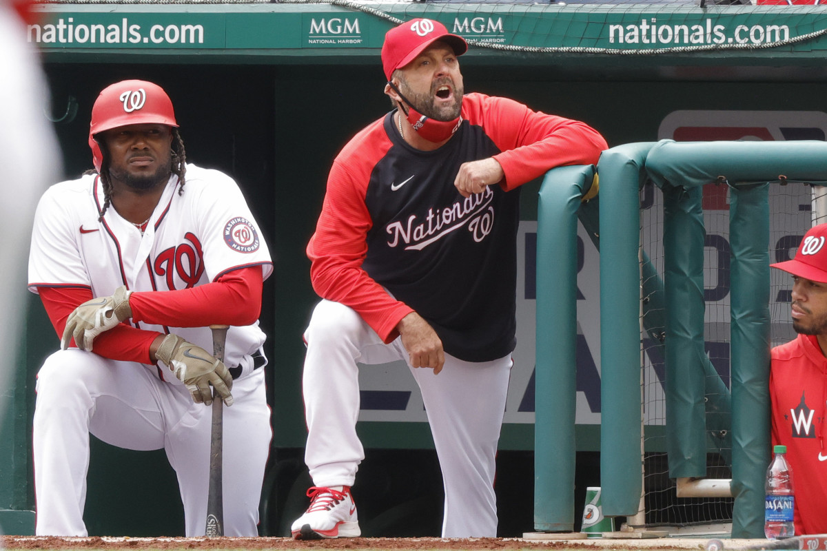 Kevin Long yells at home plate umpire Sam Holbrook after being ejected against the Milwaukee Brewers in the sixth inning at Nationals Park.