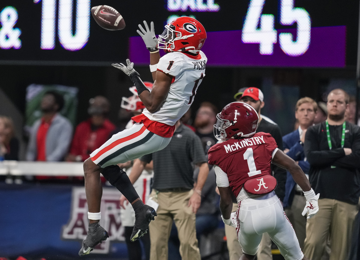 Georgia Bulldogs wide receiver George Pickens (1) catches a pass over Alabama Crimson Tide defensive back Kool-Aid McKinstry (1) during the first half at Mercedes-Benz Stadium.