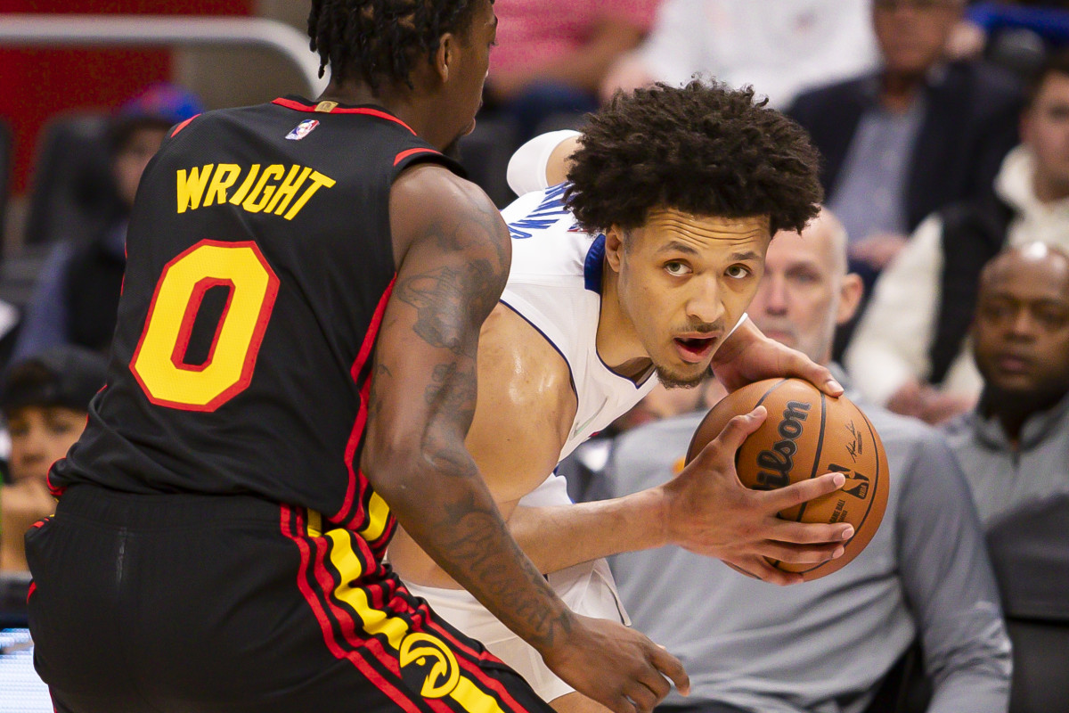 Mar 7, 2022; Detroit, Michigan, USA; Detroit Pistons guard Cade Cunningham (2) gets defended by Atlanta Hawks guard Delon Wright (0) during the third quarter at Little Caesars Arena.