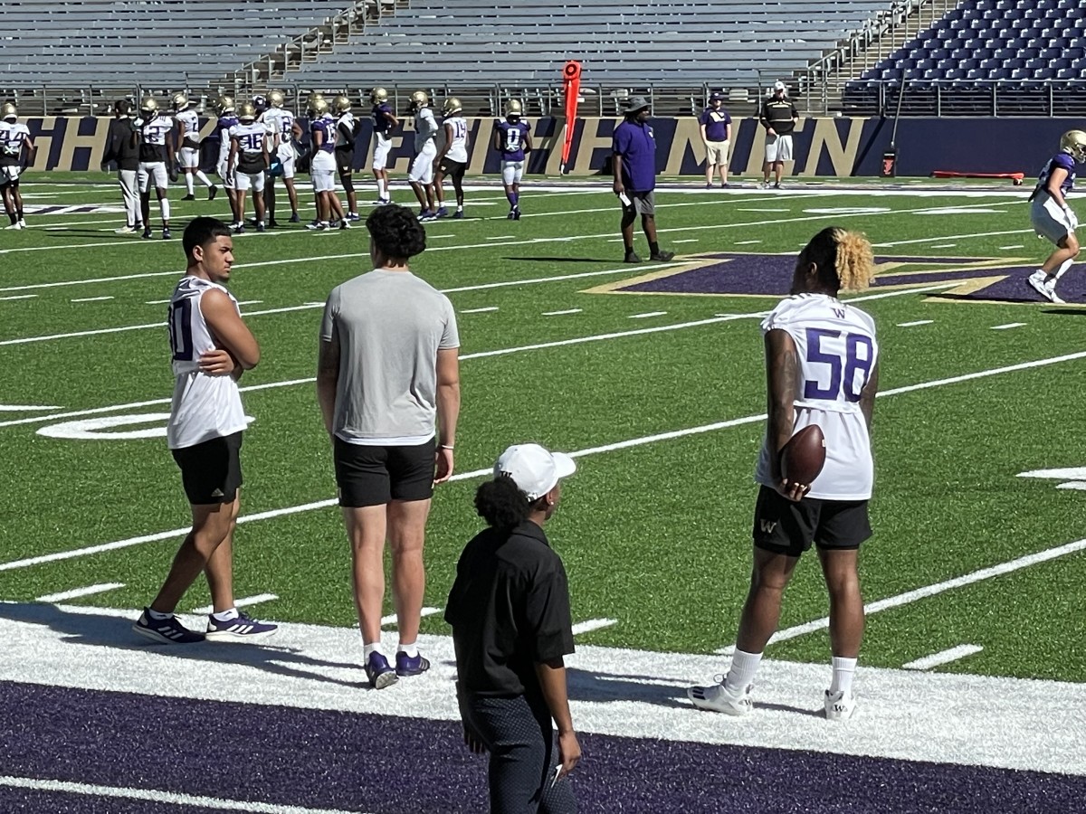 Alphonzo Tuputala, Laiatu Latu and Zion Tupuola-Fetui watch fall practice.