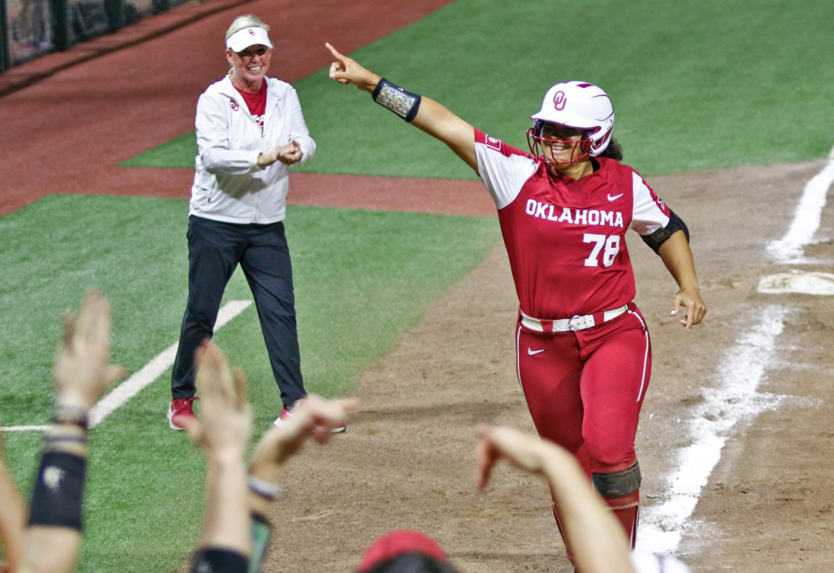 Jocelyn Alo's team greets her at home after her 96th career home run.