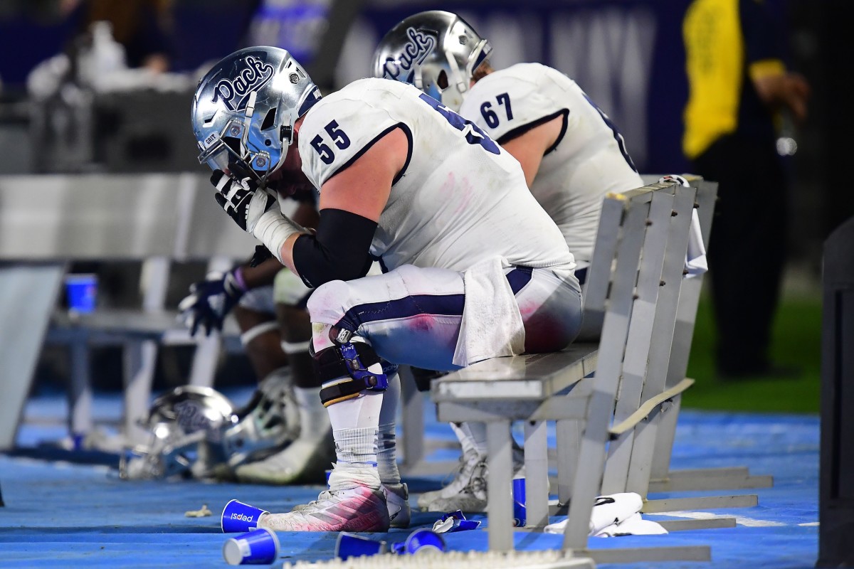 Nov 13, 2021; Carson, California, USA; Nevada Wolf Pack offensive lineman Tyler Orsini (55) and offensive lineman Aaron Frost (65) react following the loss against San Diego State Aztecs at Dignity Health Sports Park. Mandatory Credit: Gary A. Vasquez-USA TODAY Sports