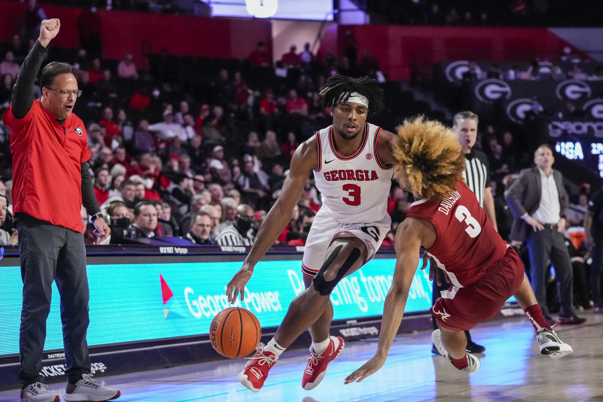 Georgia Bulldogs guard Kario Oquendo (3) dribbles past a falling Alabama Crimson Tide guard JD Davison (3) during the second half at Stegeman Coliseum.