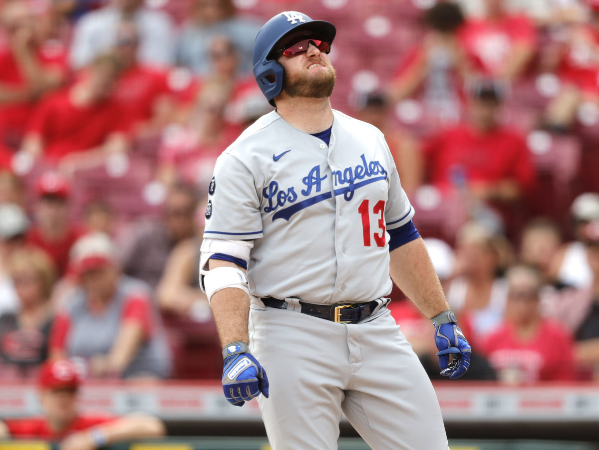 Apple TV - Los Angeles Dodgers player Max Muncy. He is wearing a white  jersey with Dodgers written across the middle and the number 13 on the left  side. He has white