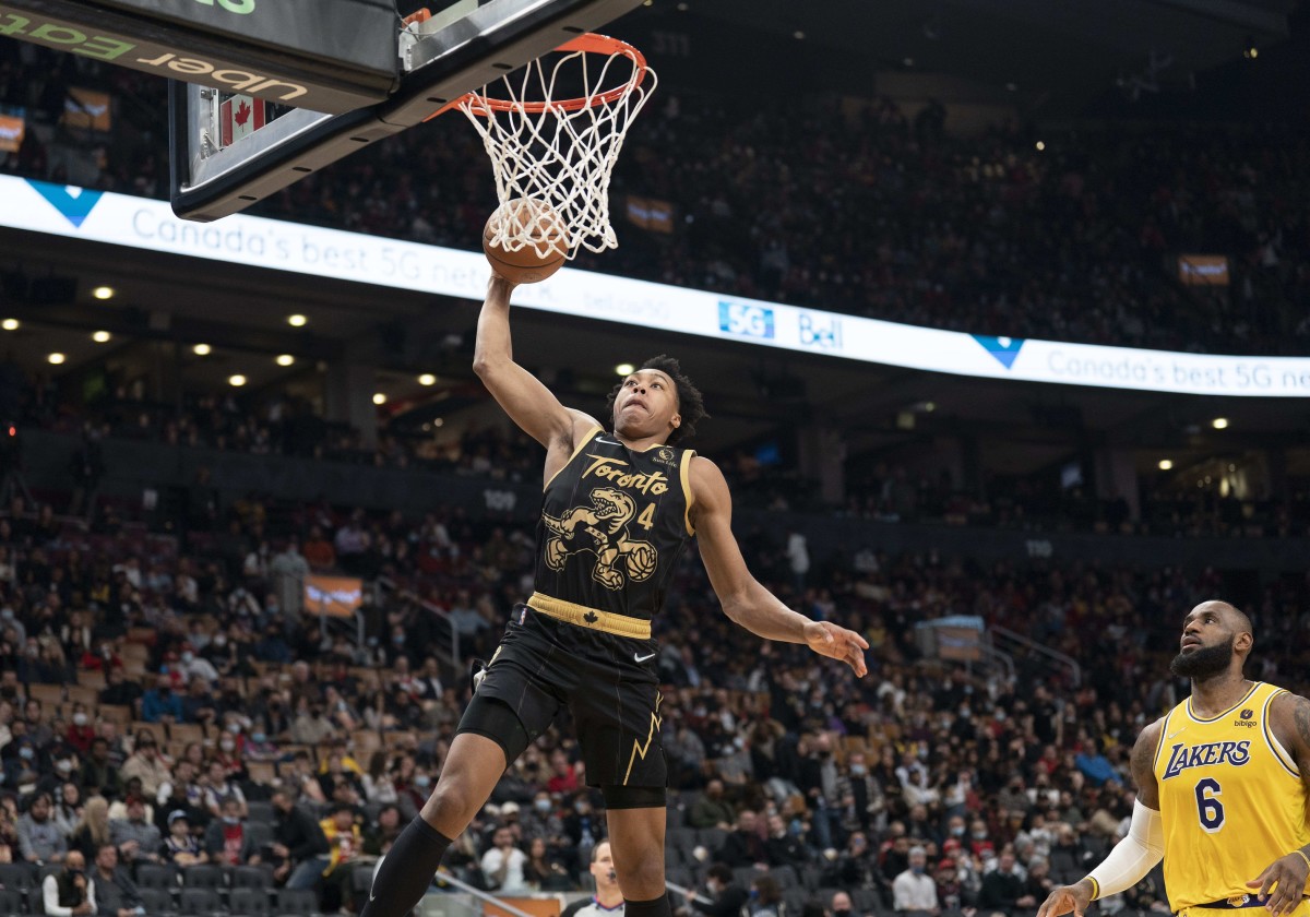 Toronto Raptors forward Scottie Barnes (4) drives to the basket over Los Angeles Lakers forward LeBron James (6) during the third quarter at Scotiabank Arena