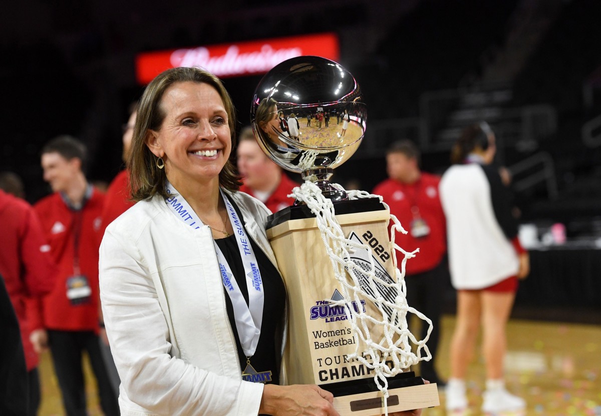 South Dakota women's basketball head coach Dawn Plitzuweit holds the Summit League trophy and game net after winning the tournament for the third year running on Tuesday, March 8, 2022, at the Denny Sanford Premier Center in Sioux Falls. Women Summit League Championship