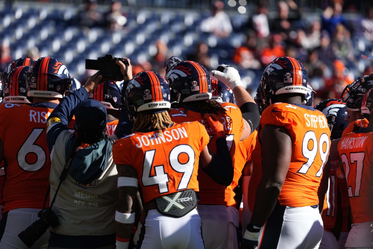 Members of the Denver Broncos huddle before the game against the Cincinnati Bengals at Empower Field at Mile High.