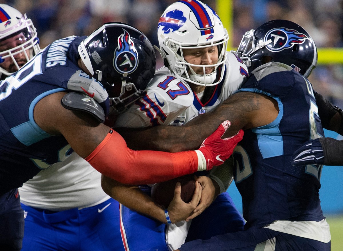 Tennessee Titans defensive end Jeffery Simmons (98) and outside linebacker Harold Landry (58) sack Buffalo Bills quarterback Josh Allen (17) during their game at Nissan Stadium Monday, Oct. 18, 2021 in Nashville, Tenn.