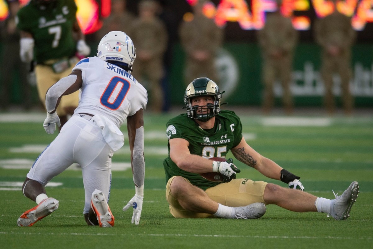 CSU football tight end Trey McBride recovers from a play after being tackled by Boise State's JL Skinner at Canvas Stadium on Saturday, Oct. 30, 2021.