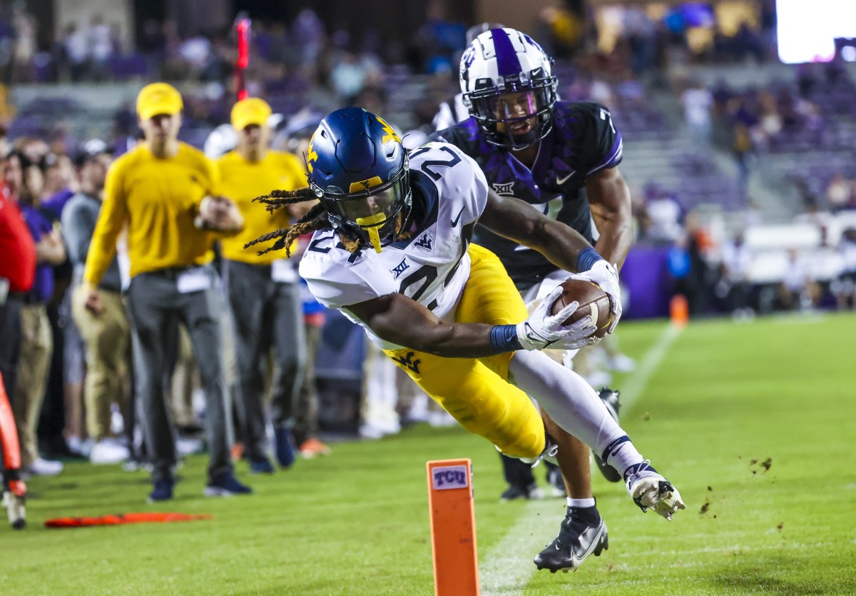 Oct 23, 2021; Fort Worth, Texas, USA; West Virginia Mountaineers running back Tony Mathis Jr. (24) dives for the endzone during the second half against the TCU Horned Frogs at Amon G. Carter Stadium.