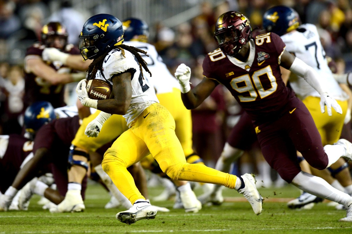 Dec 28, 2021; Phoenix, AZ, USA; West Virginia Mountaineers running back Tony Mathis Jr. (24) runs with the ball against the West Virginia Mountaineers during the first half at Chase Field.