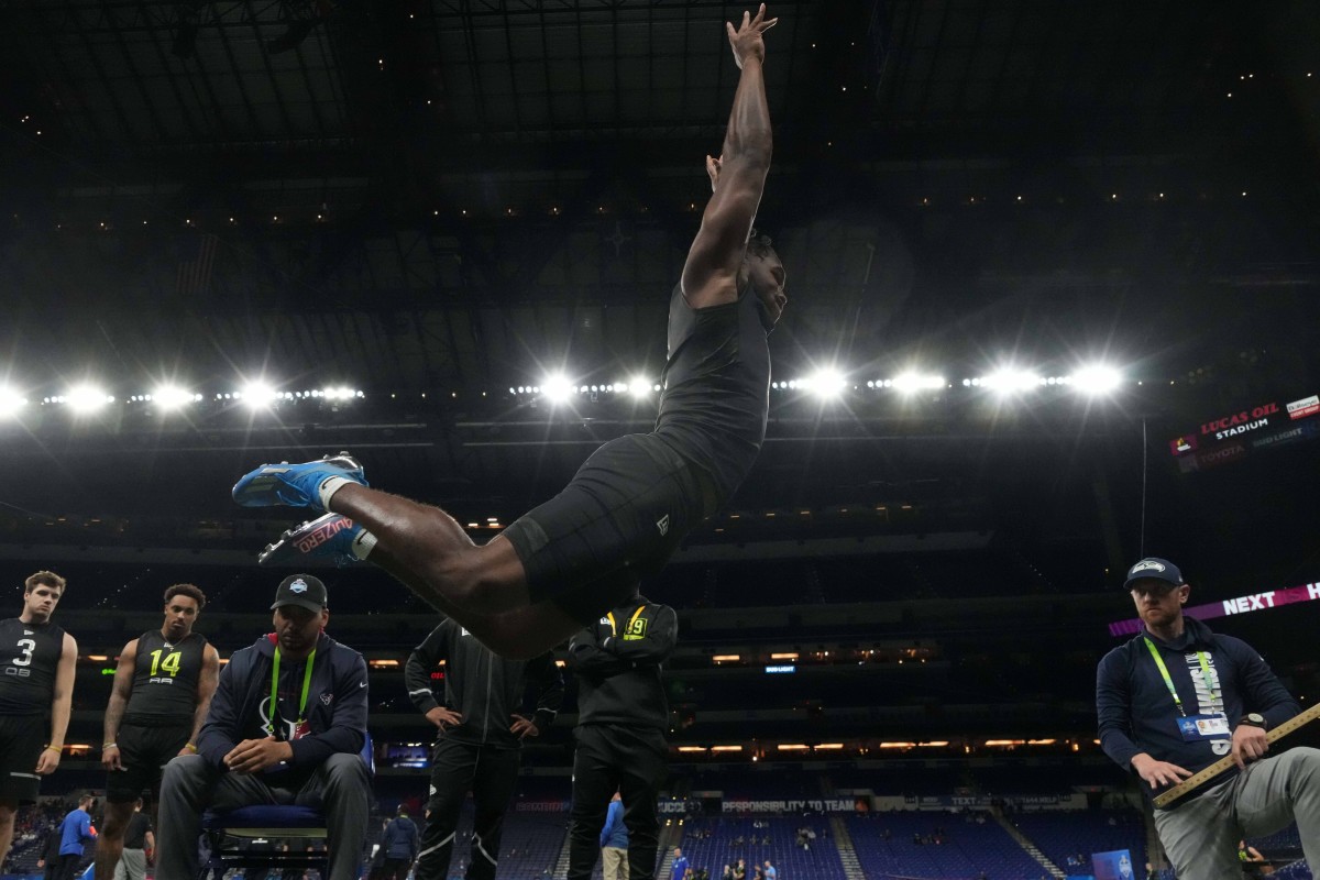 Mar 4, 2022; Indianapolis, IN, USA; Missouri Tigers running back Tyler Badie in the broad jump during the 2022 NFL Scouting Combine at Lucas Oil Stadium.