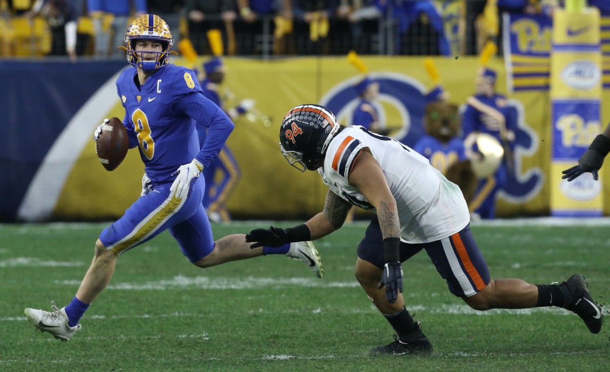 Pitt quarterback Kenny Pickett (8) runs with the ball as Virginia defensive tackle Aaron Faumui (94) chases. Mandatory Credit: Charles LeClaire-USA TODAY Sports