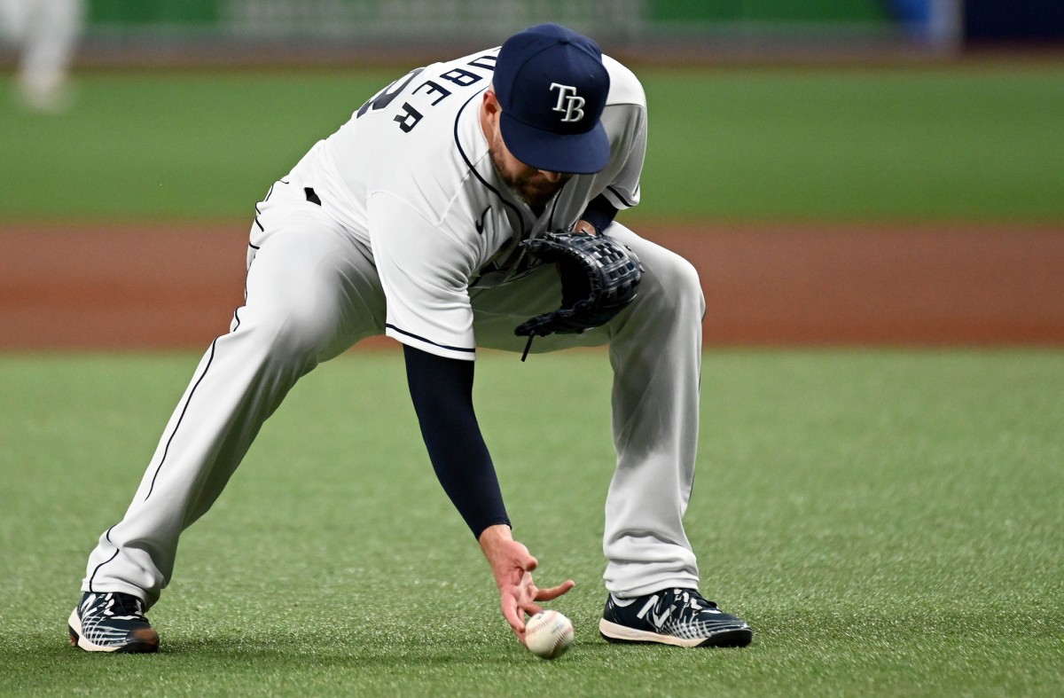 Tampa Bay Rays' Josh Lowe, left, tugs on the jersey of his brother Texas  Rangers' Nathaniel Lowe after flying out during the seventh inning of a  baseball game Sunday, June 11, 2023