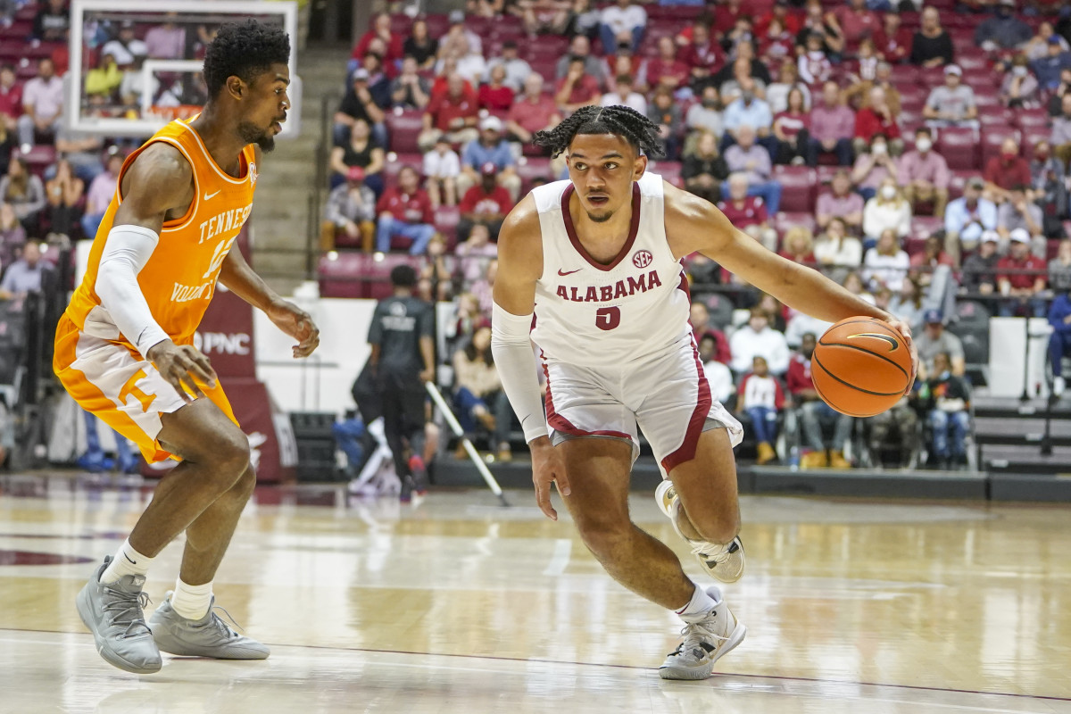 Alabama Crimson Tide guard Jaden Shackelford (5) controls the ball against Tennessee Volunteers guard Victor Bailey Jr. (12) during the second half at Coleman Coliseum.