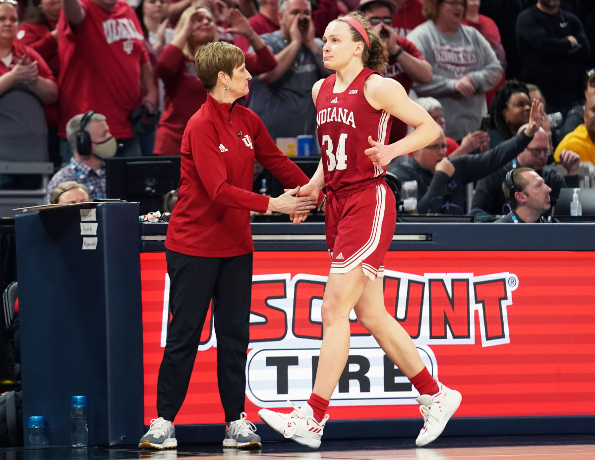 Teri Moren high-fives Grace Berger.