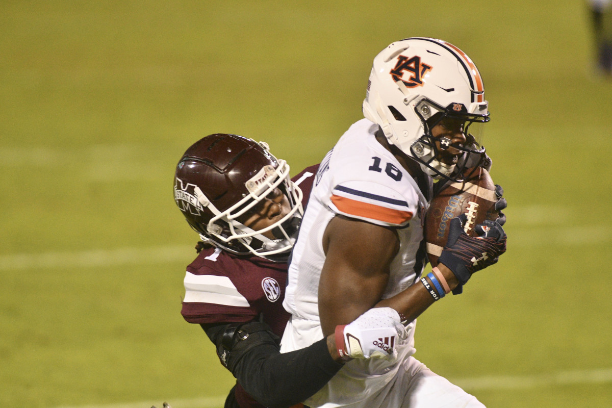 Dec 12, 2020; Starkville, Mississippi, USA;Auburn Tigers wide receiver Seth Williams (18) makes a catch for a touchdown while defended by Mississippi State Bulldogs cornerback Martin Emerson (1) during the fourth quarter at Davis Wade Stadium at Scott Field.