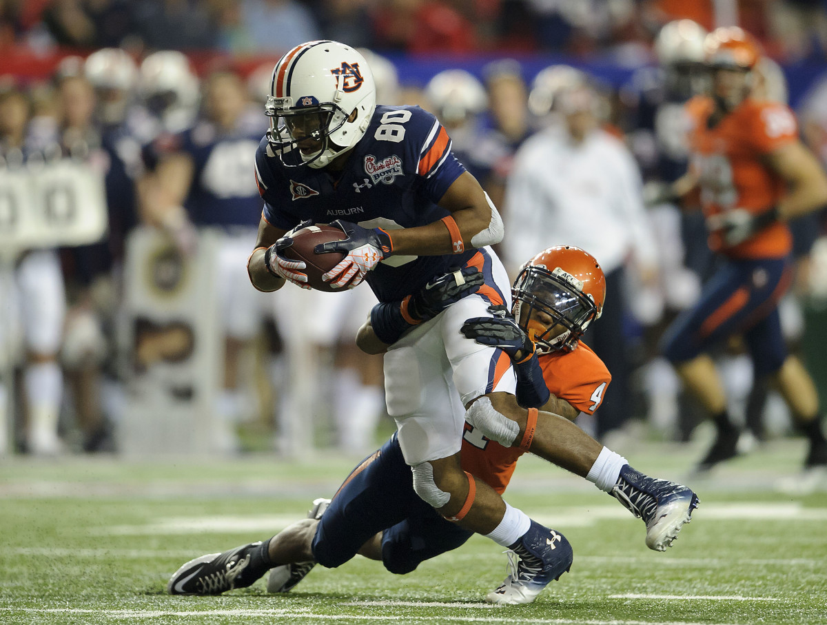 Dec 31, 2011; Atlanta, GA, USA; Auburn Tigers wide receiver Emory Blake (80) is tackled by Virginia Cavaliers safety Rodney McLeod (4) after making a reception at the Georgia Dome. Auburn won 43-28.