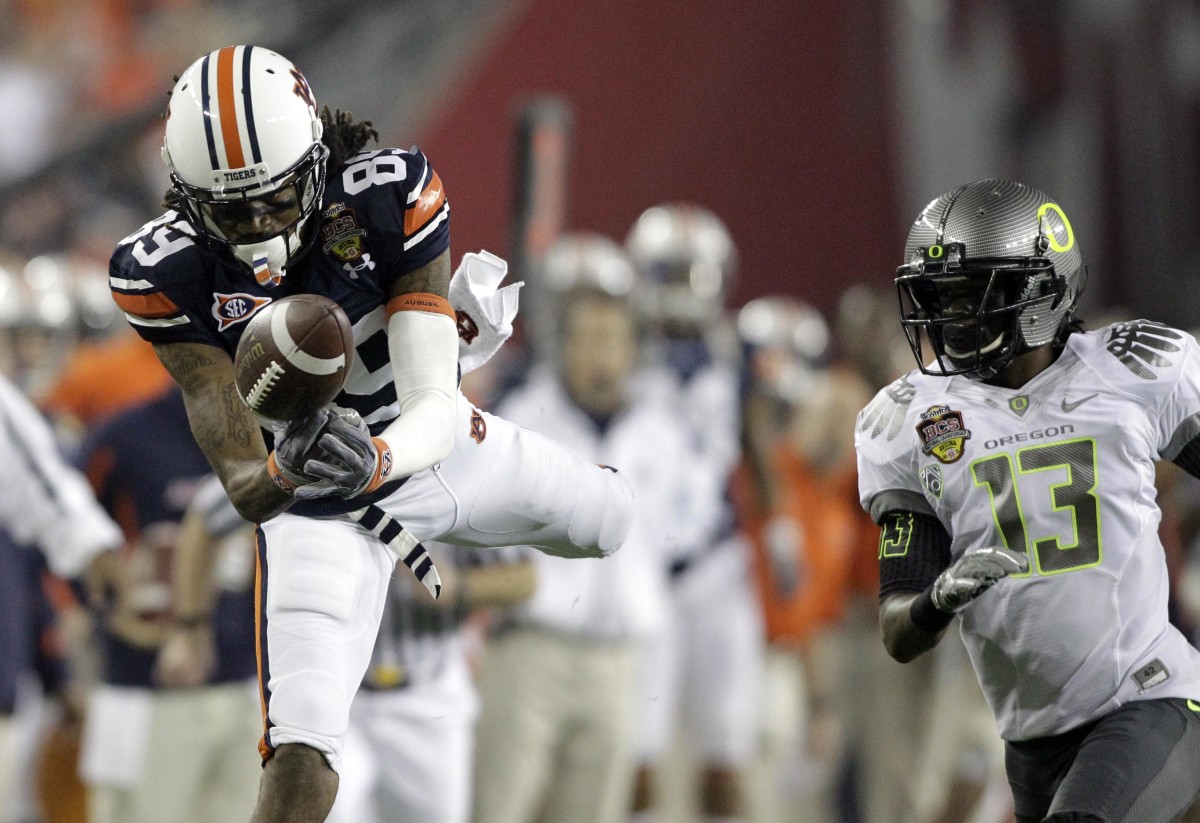 Jan 10, 2011; Glendale, AZ, USA; Auburn Tigers wide receiver Darvin Adams (89) tries to make a catch while defended by Oregon Ducks cornerback Cliff Harris (13) during the first quarter of the 2011 BCS National Championship game at University of Phoenix Stadium.