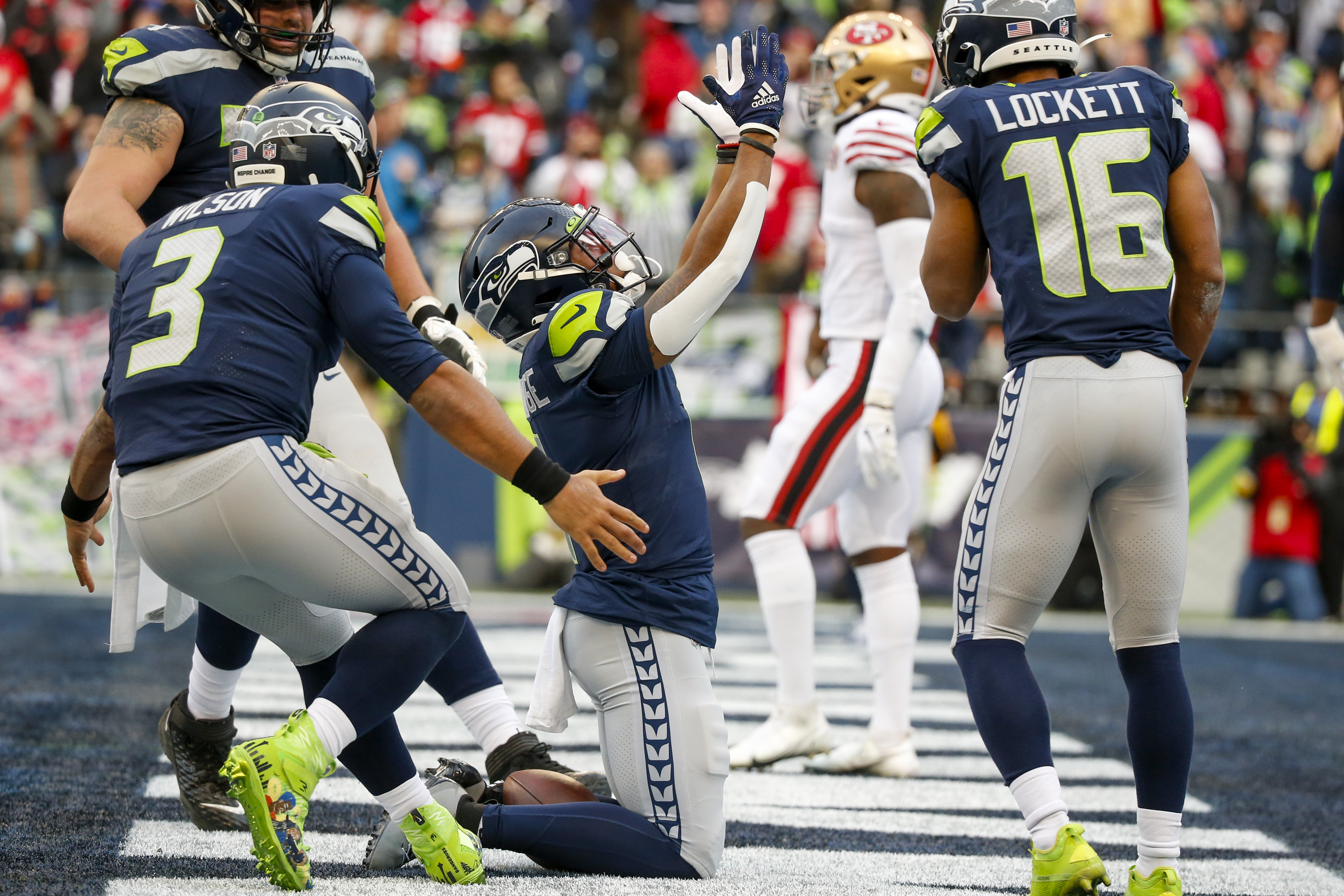 Seattle Seahawks wide receiver Dee Eskridge runs with a ball