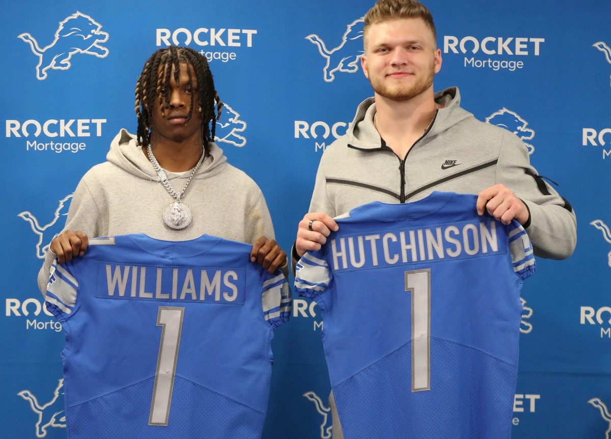 Detroit Lions first round picks receiver Jameson Williams and defensive end Aidan Hutchinson hold up their Lions' jerseys during the press conference Friday, April 29, 2022 at the Detroit Lions practice facility in Allen Park.