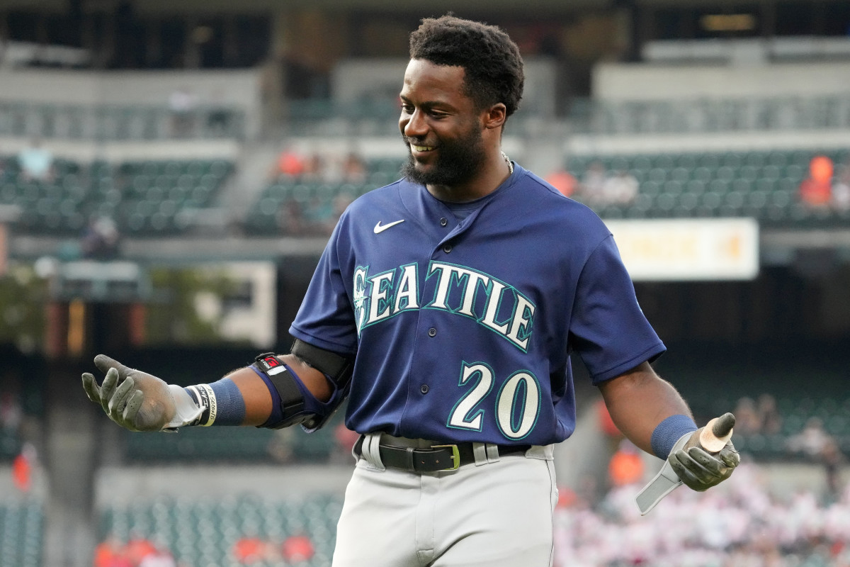 Seattle Mariners' Ty France holds a trident in the dugout after hitting a  solo home run against the Baltimore Orioles during the fifth inning of a  baseball game Friday, Aug. 11, 2023