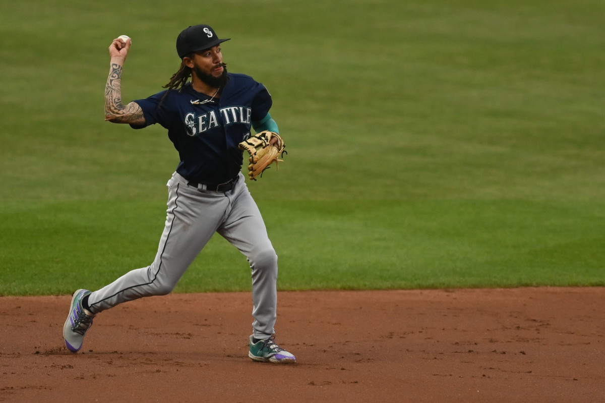 Seattle Mariners' Ty France holds a trident in the dugout after hitting a  solo home run against the Baltimore Orioles during the fifth inning of a  baseball game Friday, Aug. 11, 2023