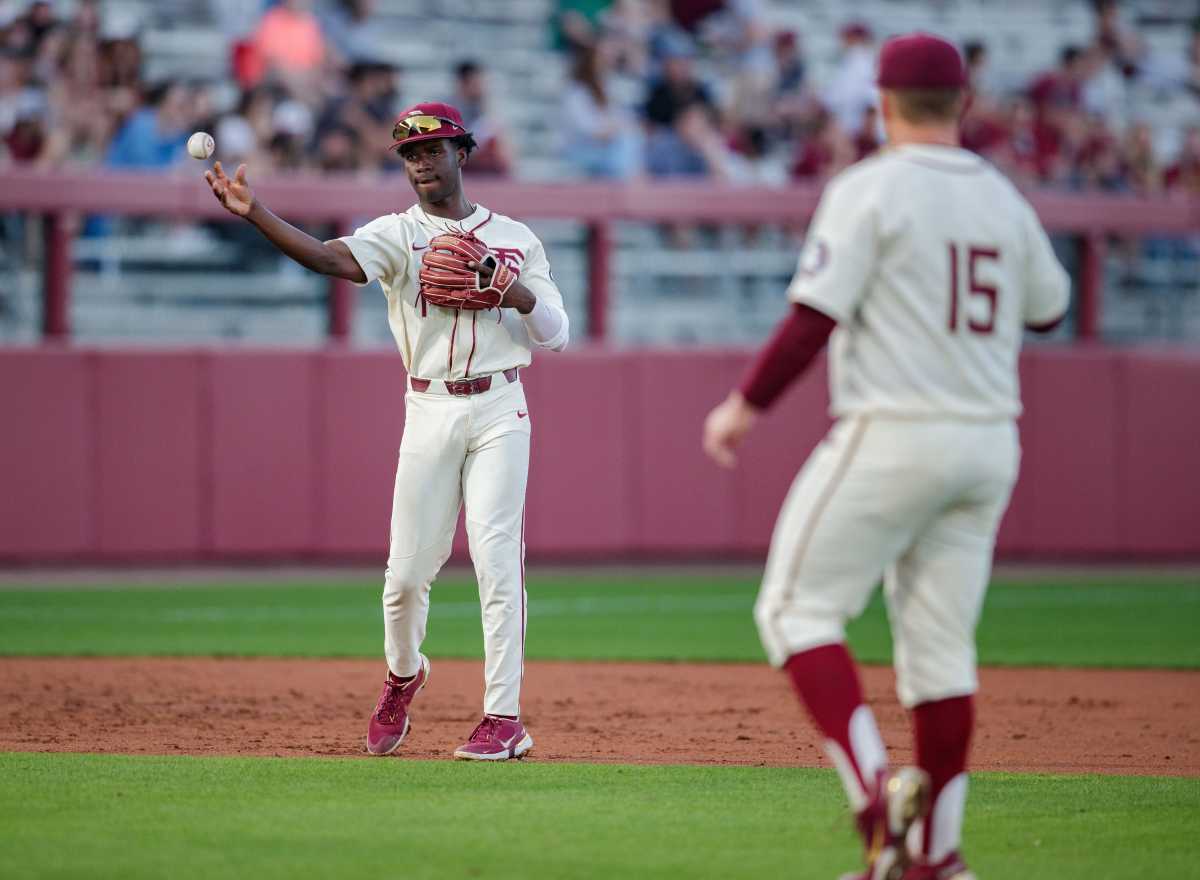 Florida State infielder Brett Roberts (1) throws the ball to pitcher Parker Messick (15). The Florida State Seminoles defeated the Samford Bulldogs 7-0 on Friday, Feb. 25, 2022. Fsu Baseball Edits009