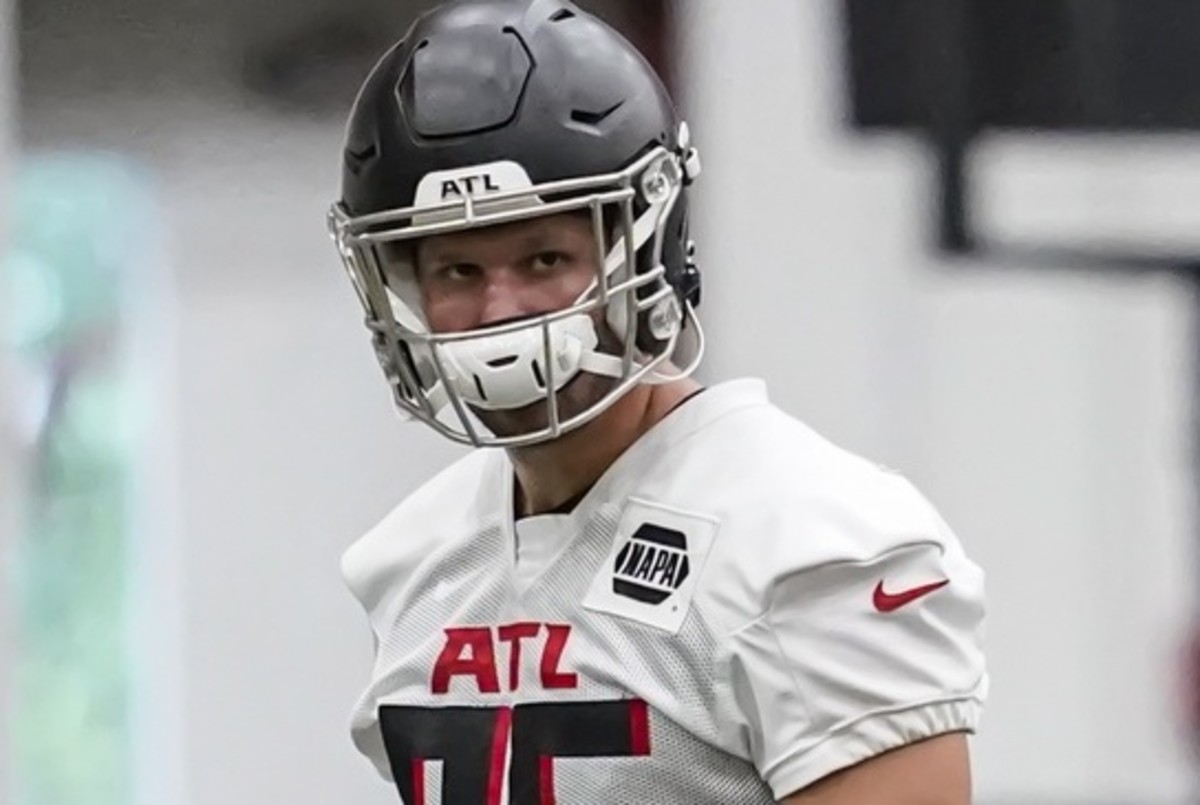 Tennessee Titans offensive guard Chandon Herring (68) fist bumps an Atlanta  police officer after a preseason NFL football game against the Atlanta  Falcons, Friday, Aug. 13, 2021, in Atlanta. The Tennessee Titans