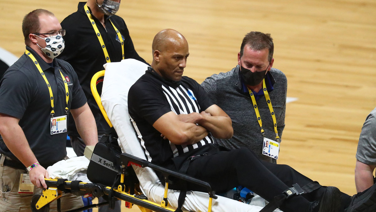 Referee Bert Smith is carted off the court in the Elite Eight