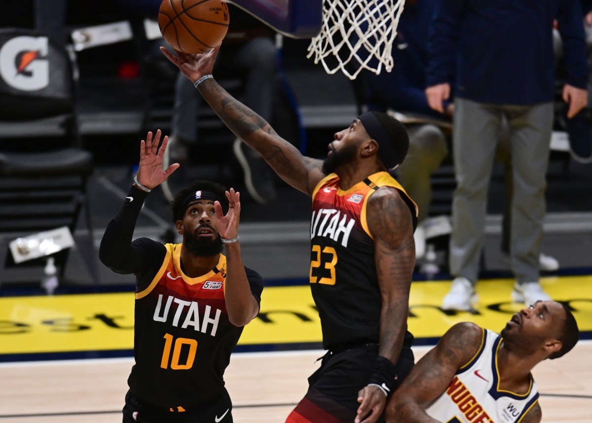 Royce O'Neale (23) scores against the Denver Nuggets