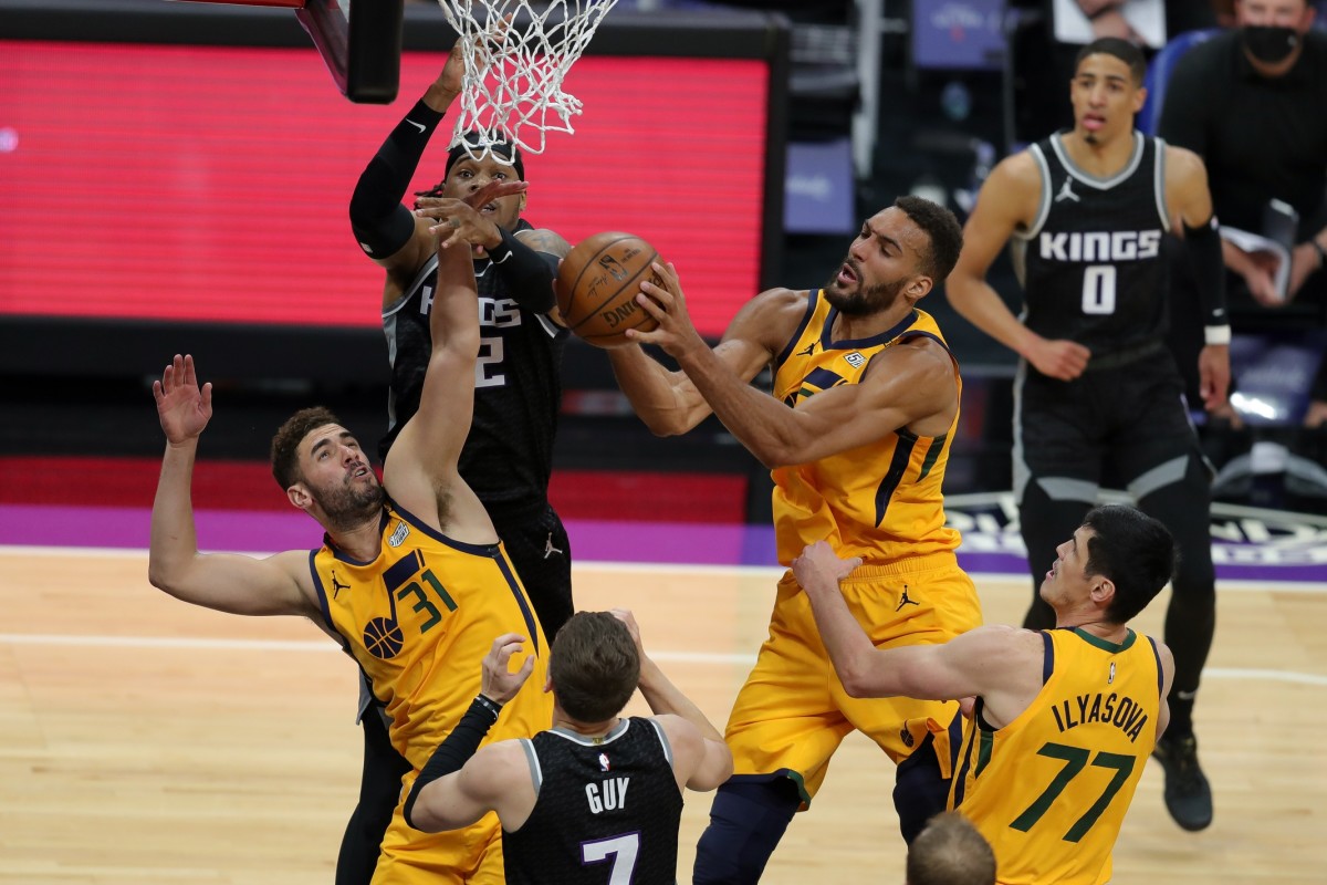 Rudy Gobert (27) snags a rebound against the Sacramento Kings