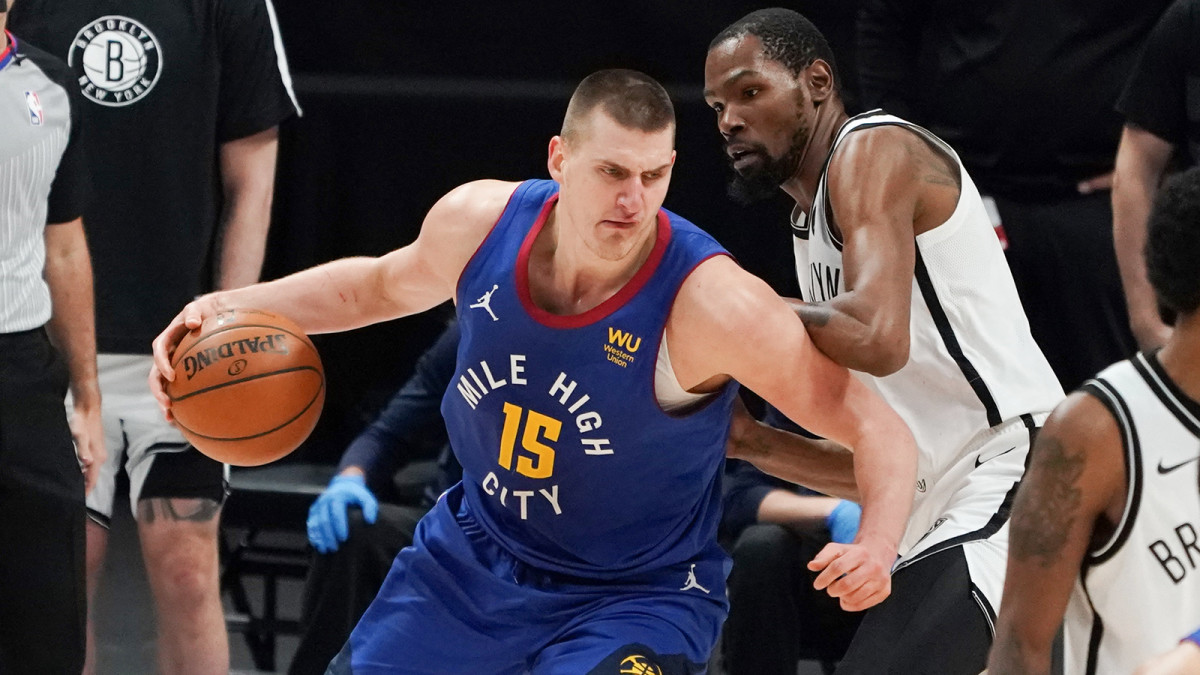 Nikola Jokic controls the ball against Brooklyn Nets forward Kevin Durant