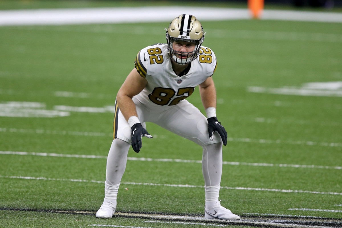 New Orleans Saints tight end Adam Trautman (82) runs the ball up the field  during an NFL football game against the Minnesota Vikings at Tottenham  Hotspur Stadium, Sunday, Oct. 2, 2022, in