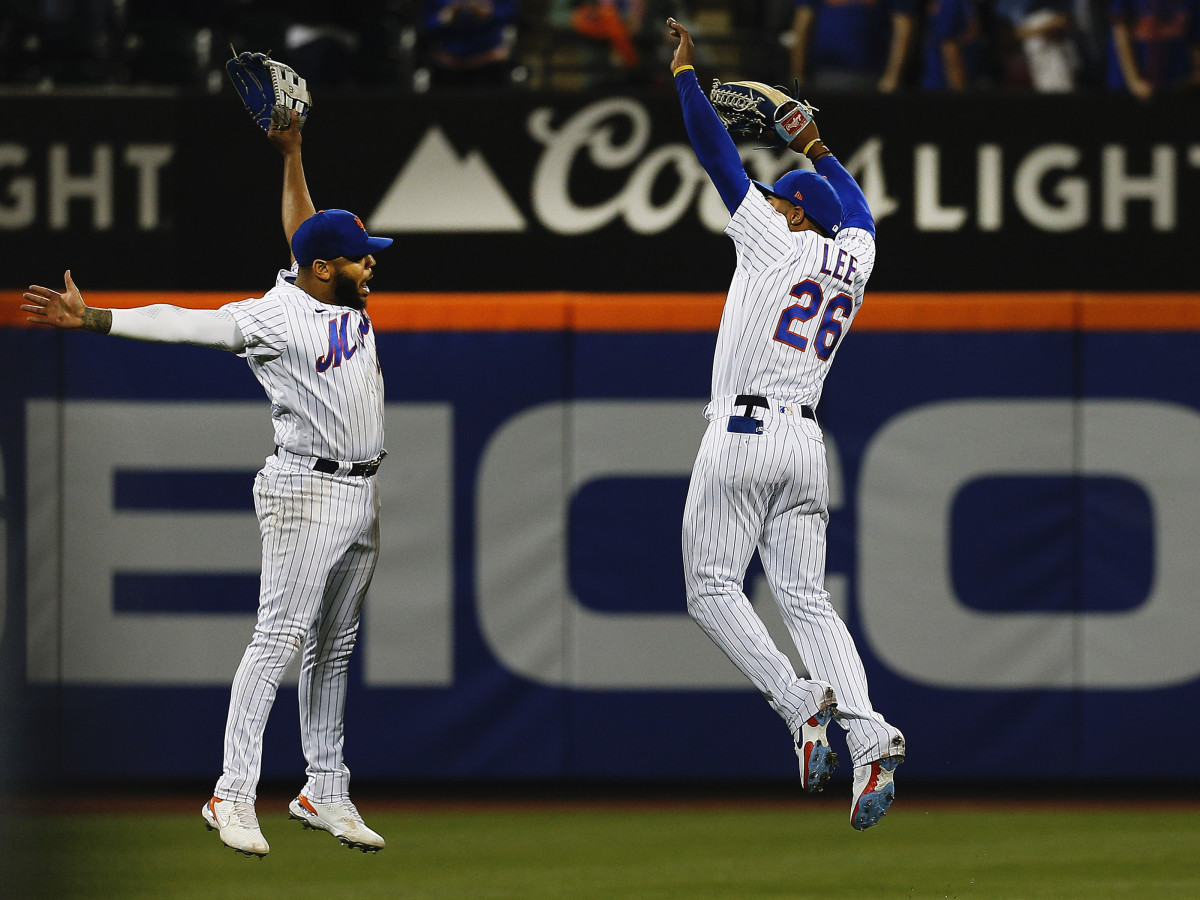 New York Mets left fielder Dominic Smith (left) and right fielder Khalil Lee (26) leap in celebration after defeating the Colorado Rockies at Citi Field.