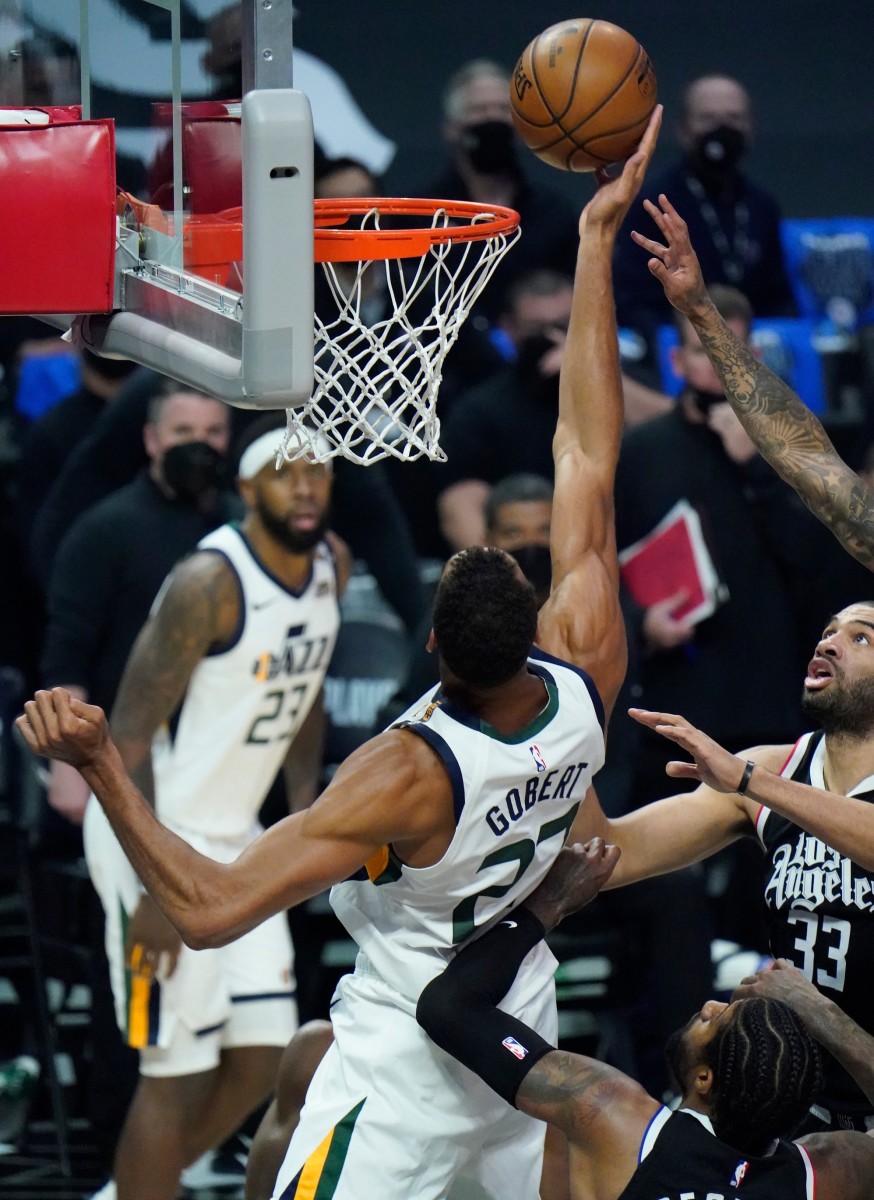 Rudy Gobert (27) scores on a put-back layup over Paul George (13) and Nicolas Batum (33)