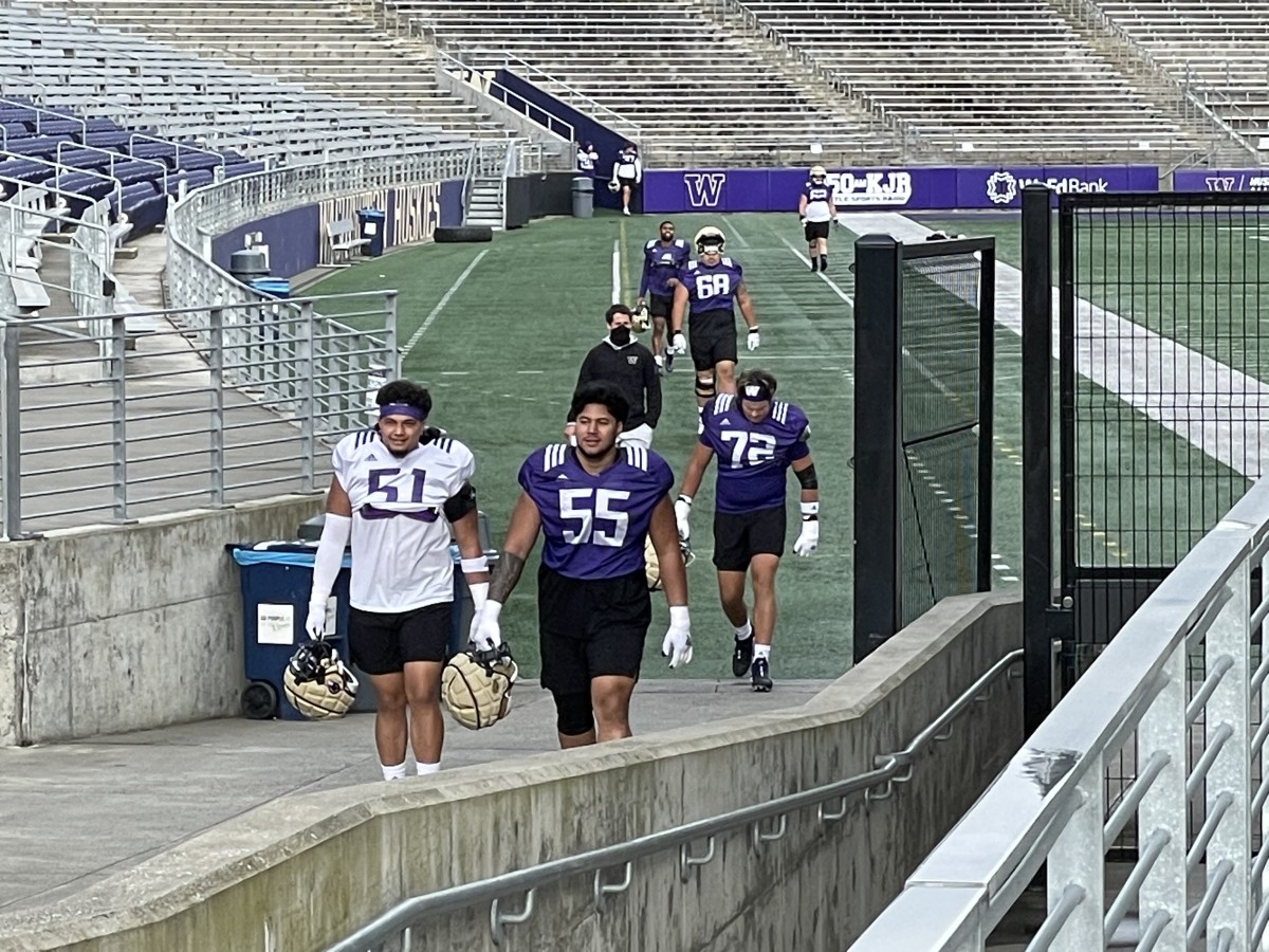 Jordan Lolohea and Troy Fautanu walk to spring practice.