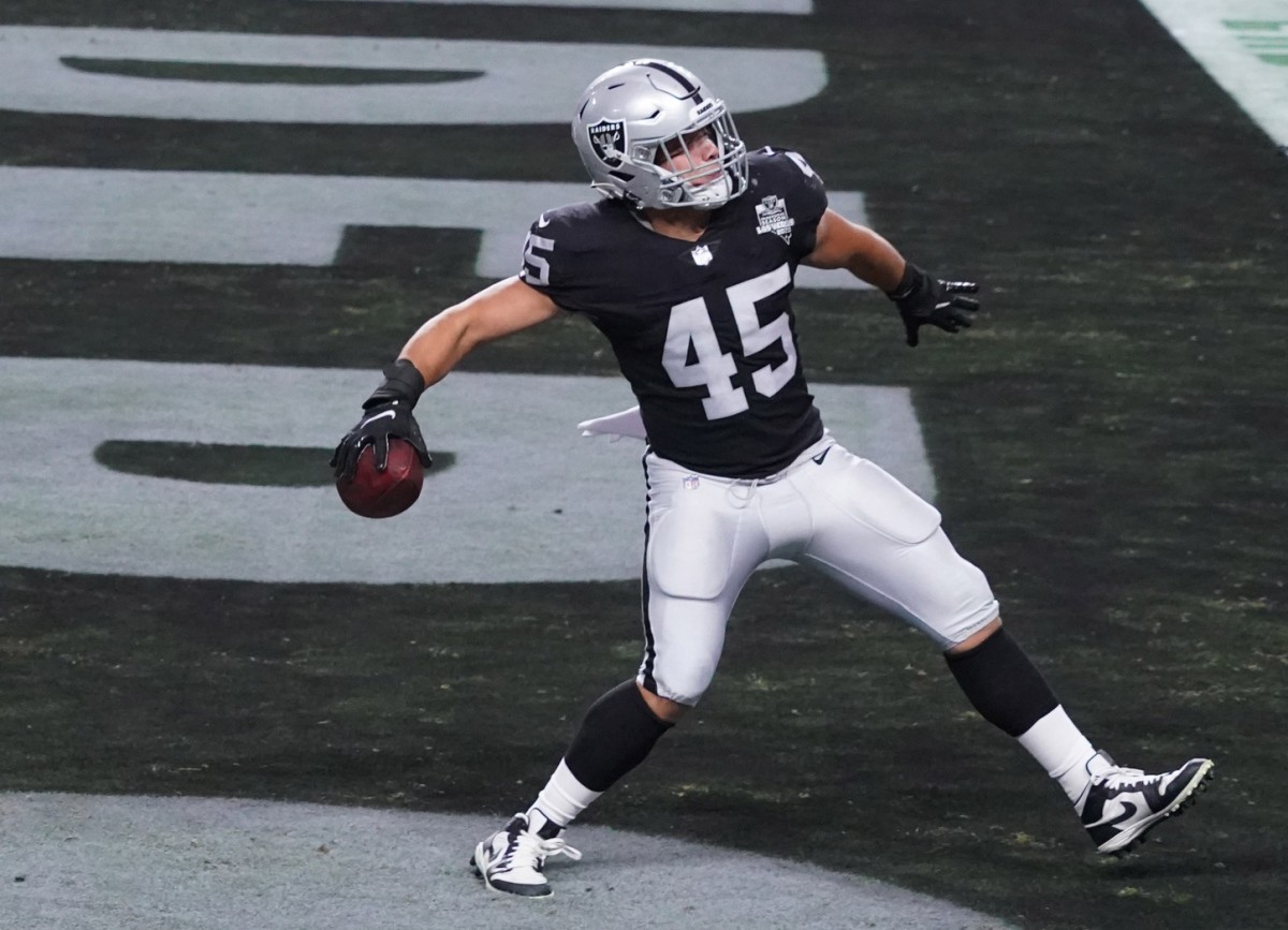 Fullback Alec Ingold of the Las Vegas Raiders spikes the football in