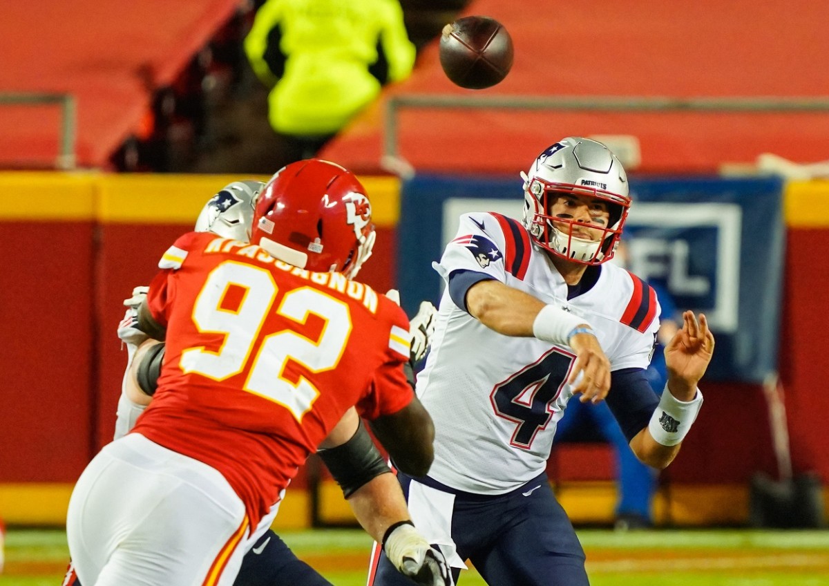 New England quarterback Jarrett Stidham (4) throws a pass as Chiefs defensive end Tanoh Kpassagnon (92) defends. Mandatory Credit: Jay Biggerstaff-USA TODAY 