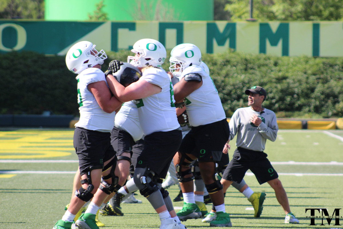 Charlie Pickard (65) goes through medicine ball work in fall camp.