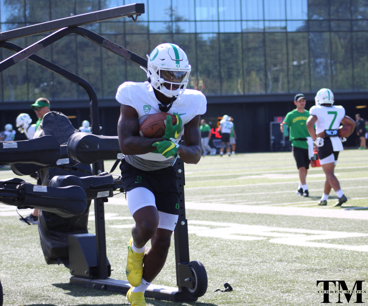 Seven McGee runs through drills with Jim Mastro and the running backs at fall camp.