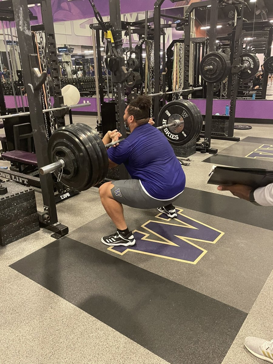 Nate Kalepo builds strength in the weight room.