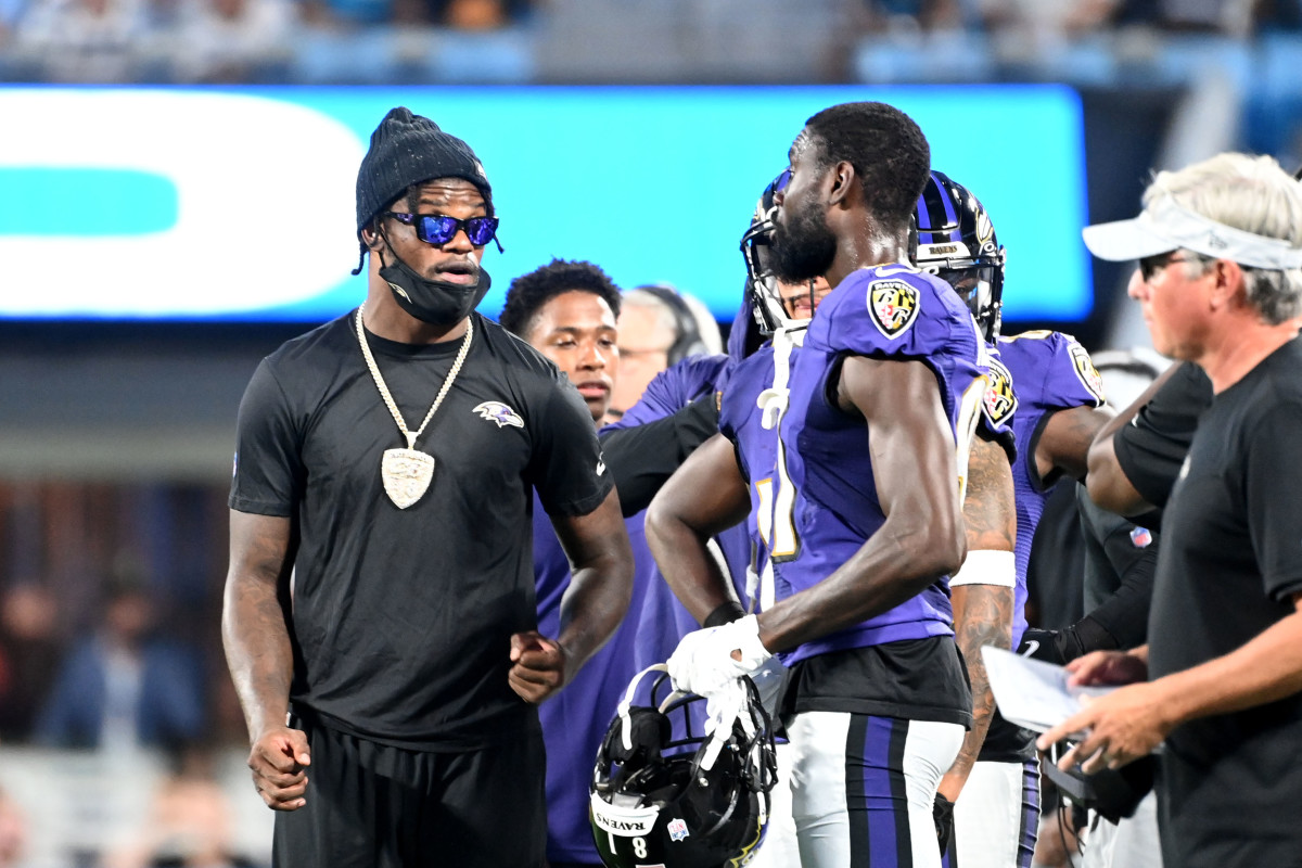 Baltimore Ravens quarterback Lamar Jackson (8) takes to the field with a  member of the military as part of Salute to Service before an NFL football  game against the Carolina Panthers, Sunday