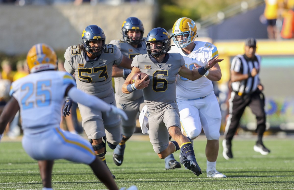 Sep 11, 2021; Morgantown, West Virginia, USA; West Virginia Mountaineers quarterback Garrett Greene (6) runs from the pocket against the Long Island Sharks during the second quarter at Mountaineer Field at Milan Puskar Stadium.