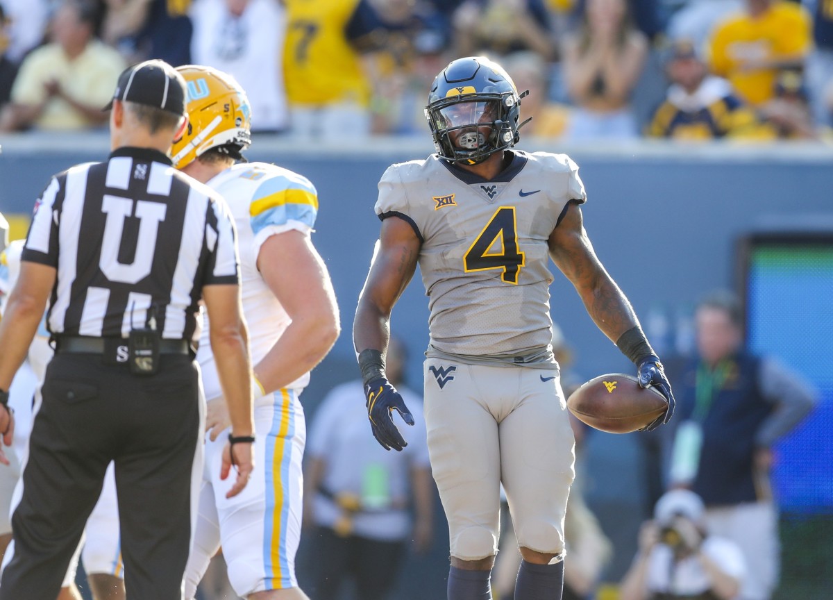 West Virginia Mountaineers running back Leddie Brown (4) runs for a touchdown during the first quarter against the Long Island Sharks at Mountaineer Field at Milan Puskar Stadium.