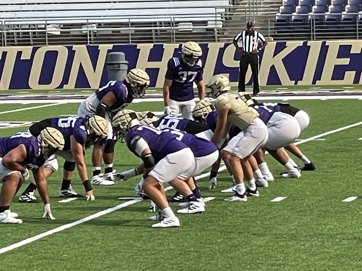 Sam Huard takes a fall camp practice snap.