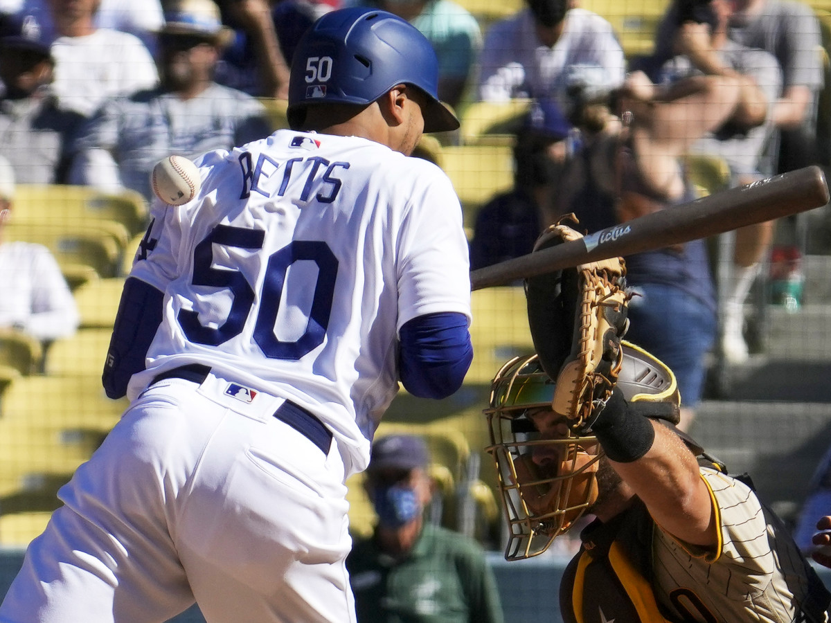 Sep 12, 2021; Los Angeles, California, USA; Los Angeles Dodgers center fielder Mookie Betts (50) gets hit in the back by a pitch from San Diego Padres reliever Austin Adams (not pictured) in the eighth inning at Dodger Stadium.