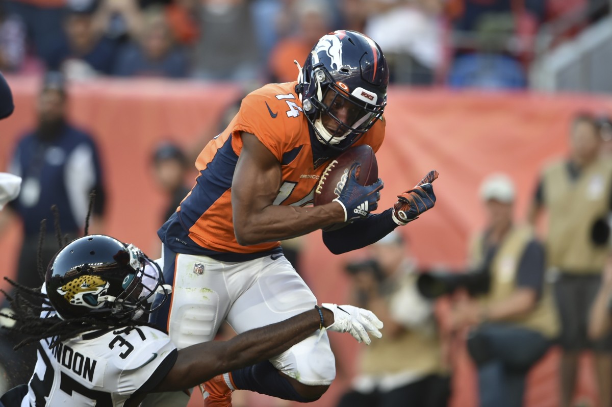 Denver Broncos wide receiver Courtland Sutton (14) hauls in a touchdown catch in the fourth quarter with Jacksonville Jaguars cornerback Tre Herndon (37) defending at Empower Field at Mile High.