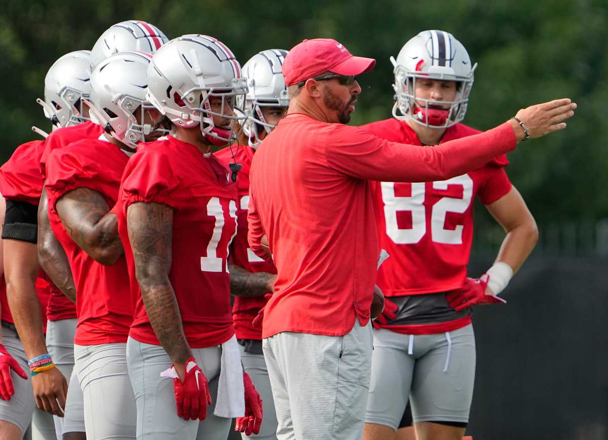 Ohio State wide receivers coach Brian Hartline talks to his players during a practice in Columbus.