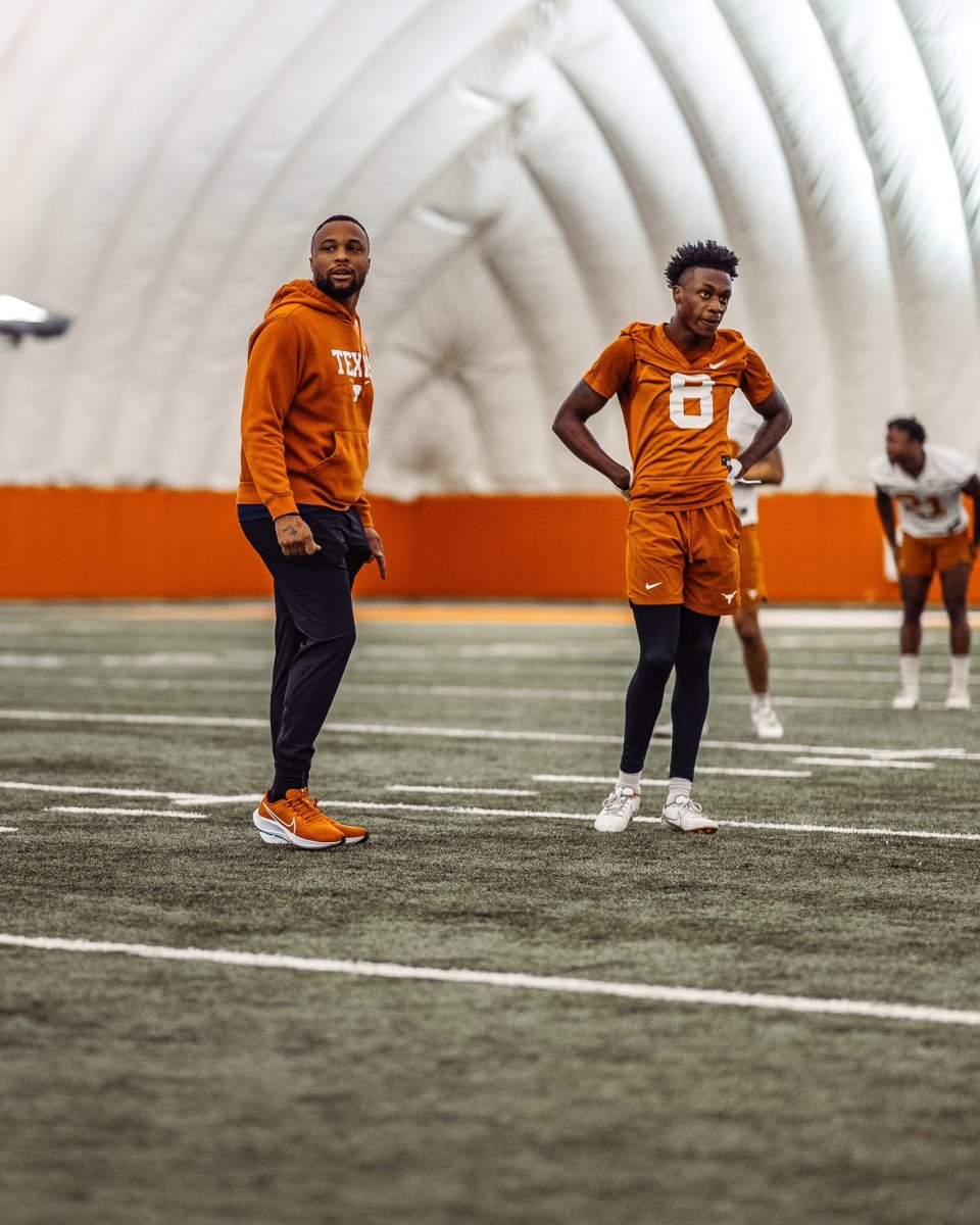 Texas wide receivers coach Brennan Marion with Xavier Worthy.